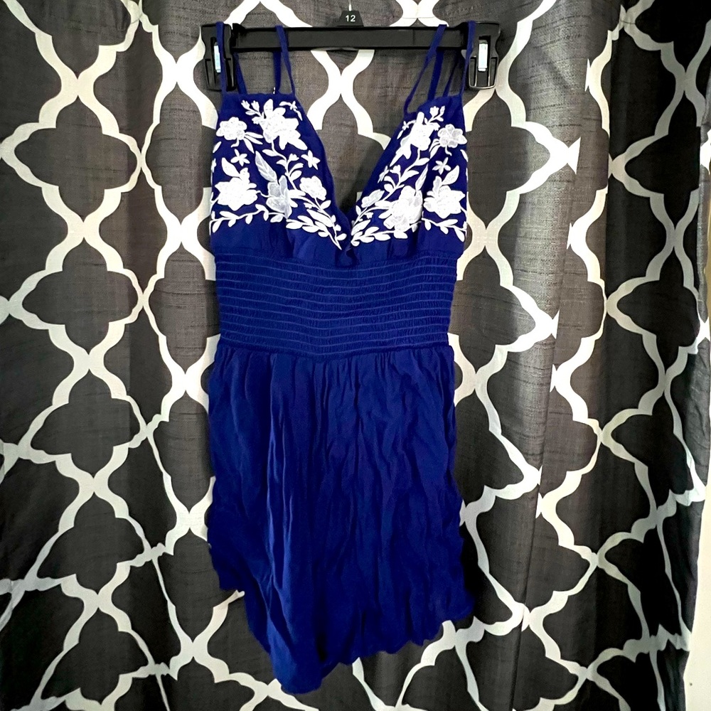 Medium blue romper, with white floral design on top, scrunched/tight waist